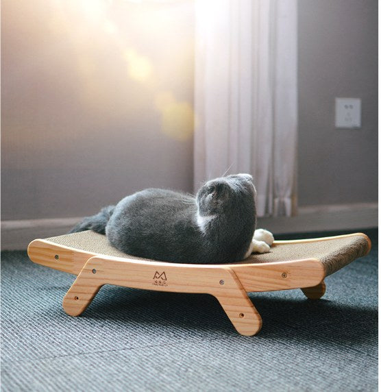 Cat lying on a low corrugated cat scratcher lounge bed